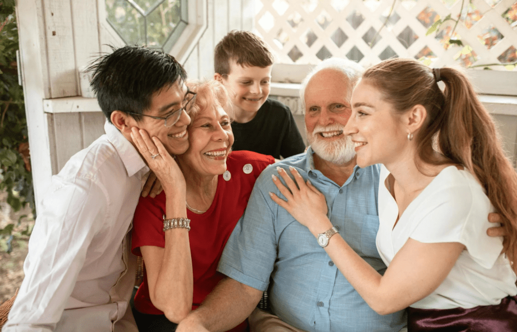 A couple at a family gathering, exchanging knowing looks