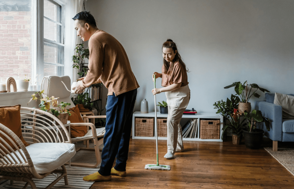 A couple cleaning or parenting together at home