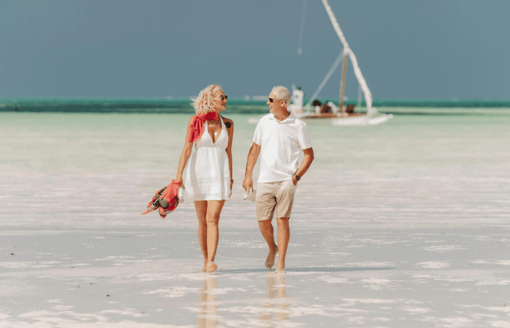 A couple lounging on a porch or walking on the beach