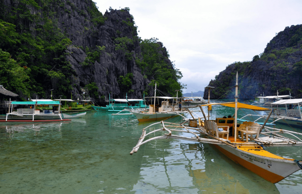Hidden beach lagoons and colorful boats in Palawan