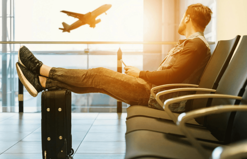 A traveler waiting at an airport gate