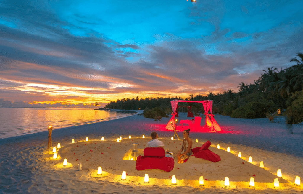 A candlelit private dinner on the beach or rooftop