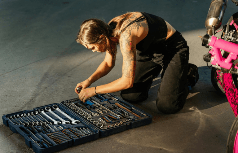 A person organizing tools or sweeping out a garage