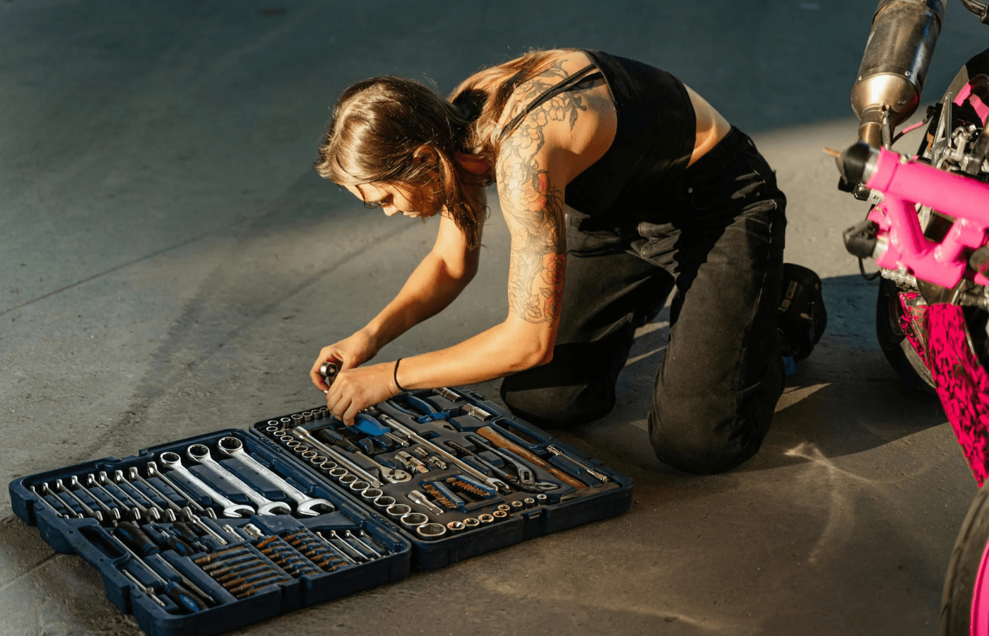 A person organizing tools or sweeping out a garage