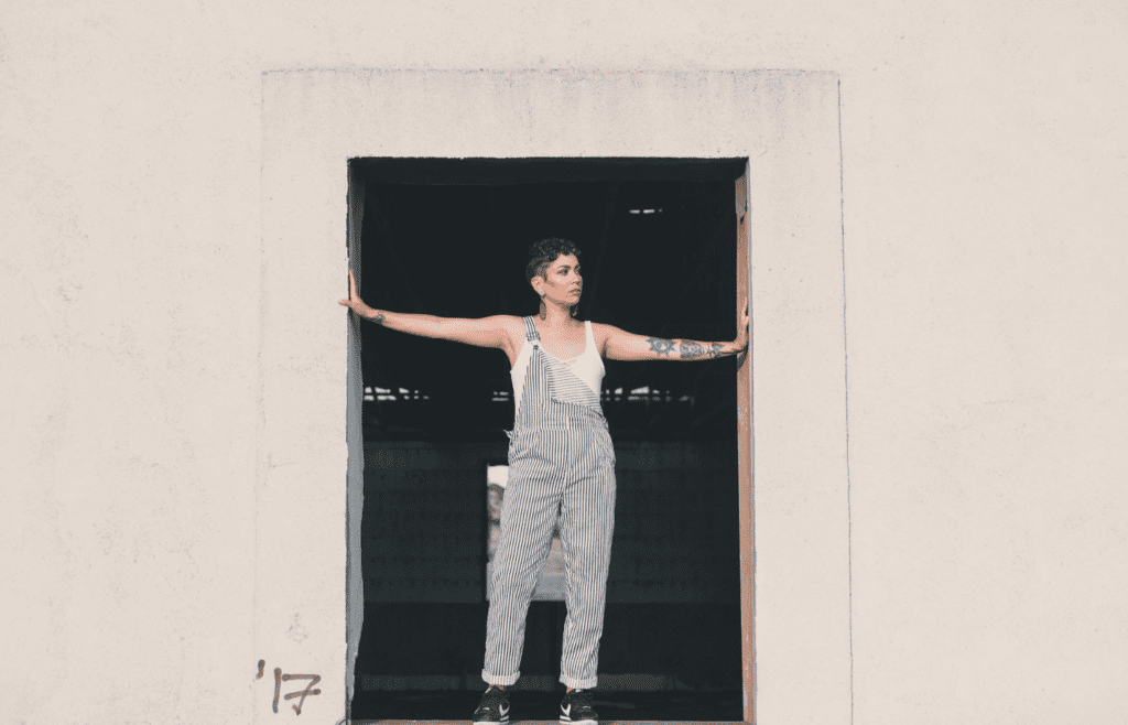 A person confidently standing in a doorway