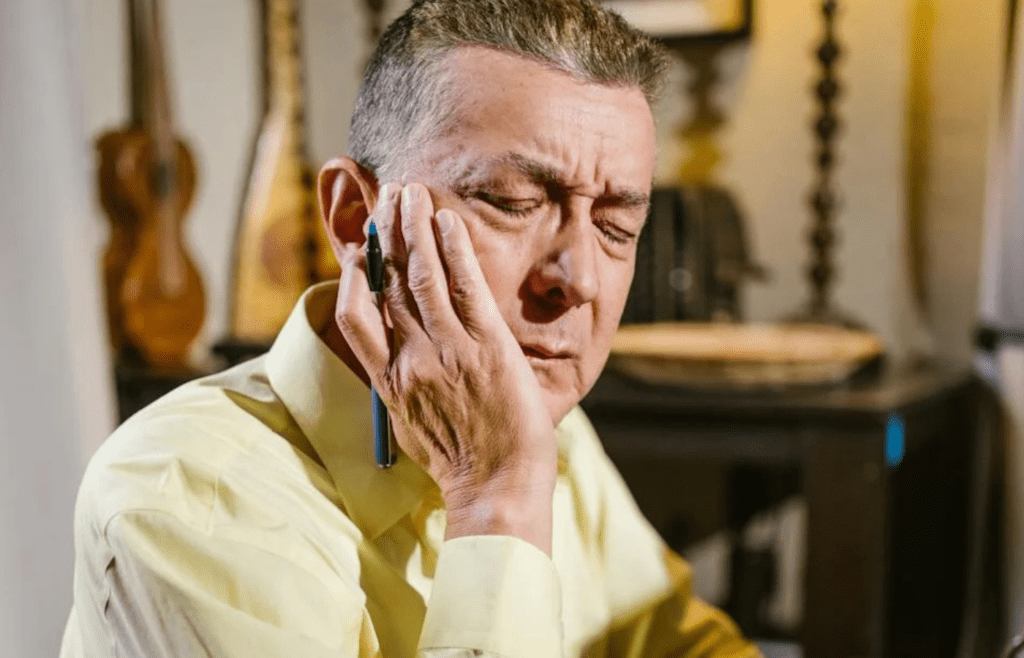 A person writing or thinking quietly with eyes closed