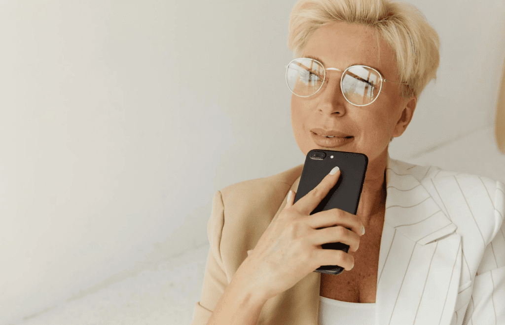 A person thinking while holding their phone
