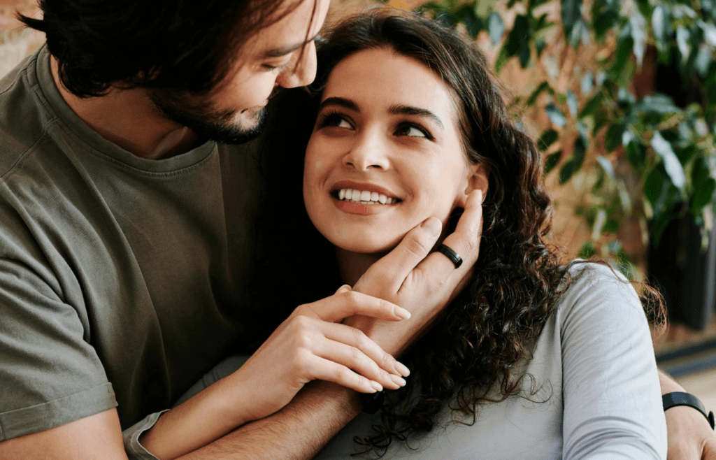 A couple smiling with quiet confidence in each other