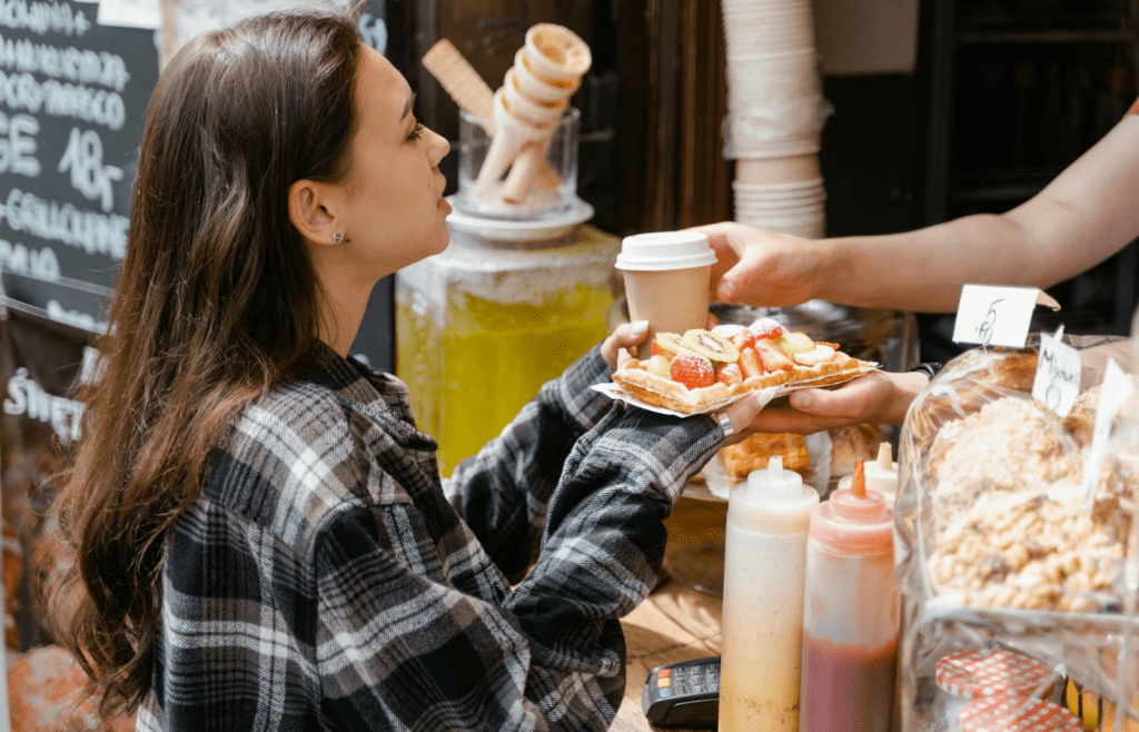 A traveler enjoying street food at a market