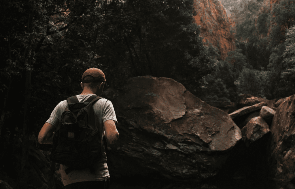 A traveler hiking through a scenic trail