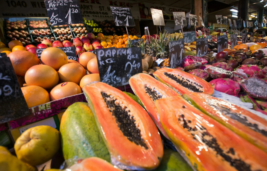 A colorful outdoor market filled with fruits and crafts