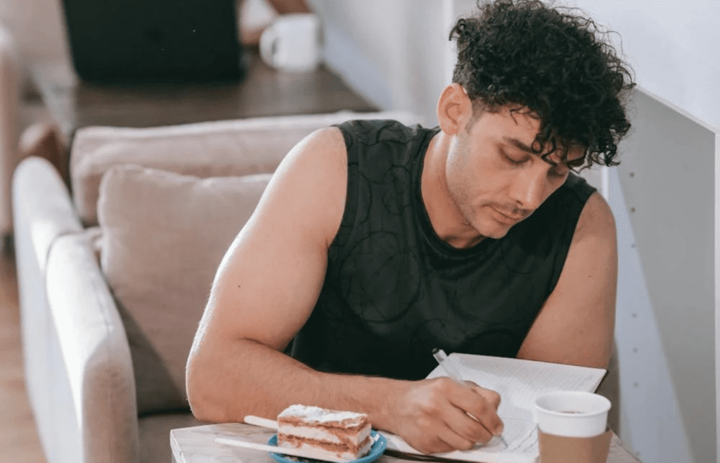 A traveler using a phrasebook at a café