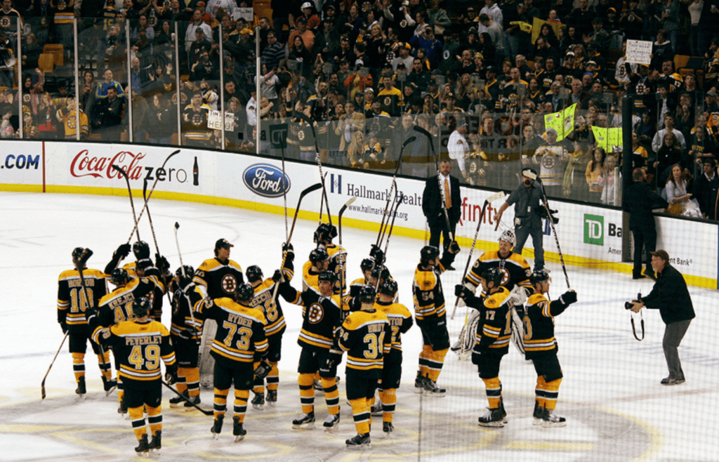 Bruins team celebrating win with loyal fans