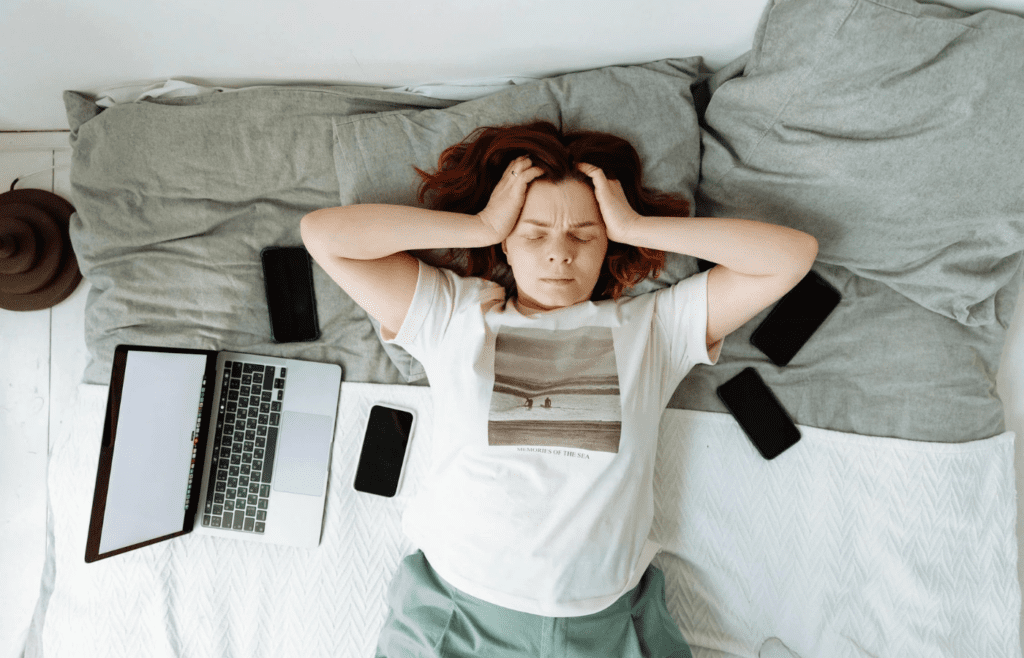 A person overwhelmed by multiple screens or papers