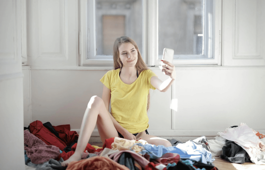 A messy room with scattered items and laundry