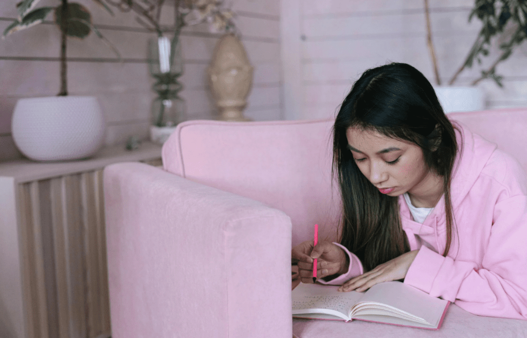 A person looking frustrated while writing in a notebook