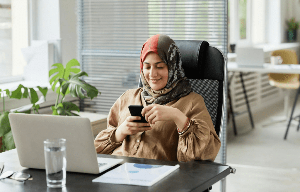 A person glued to their phone with work emails