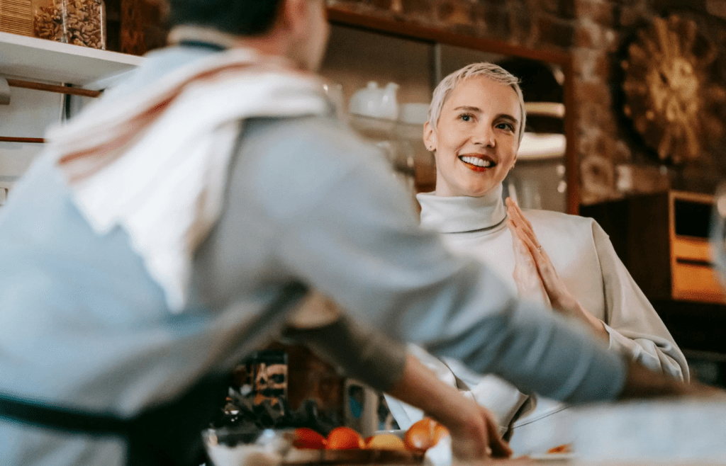 A partner helping the other cook dinner