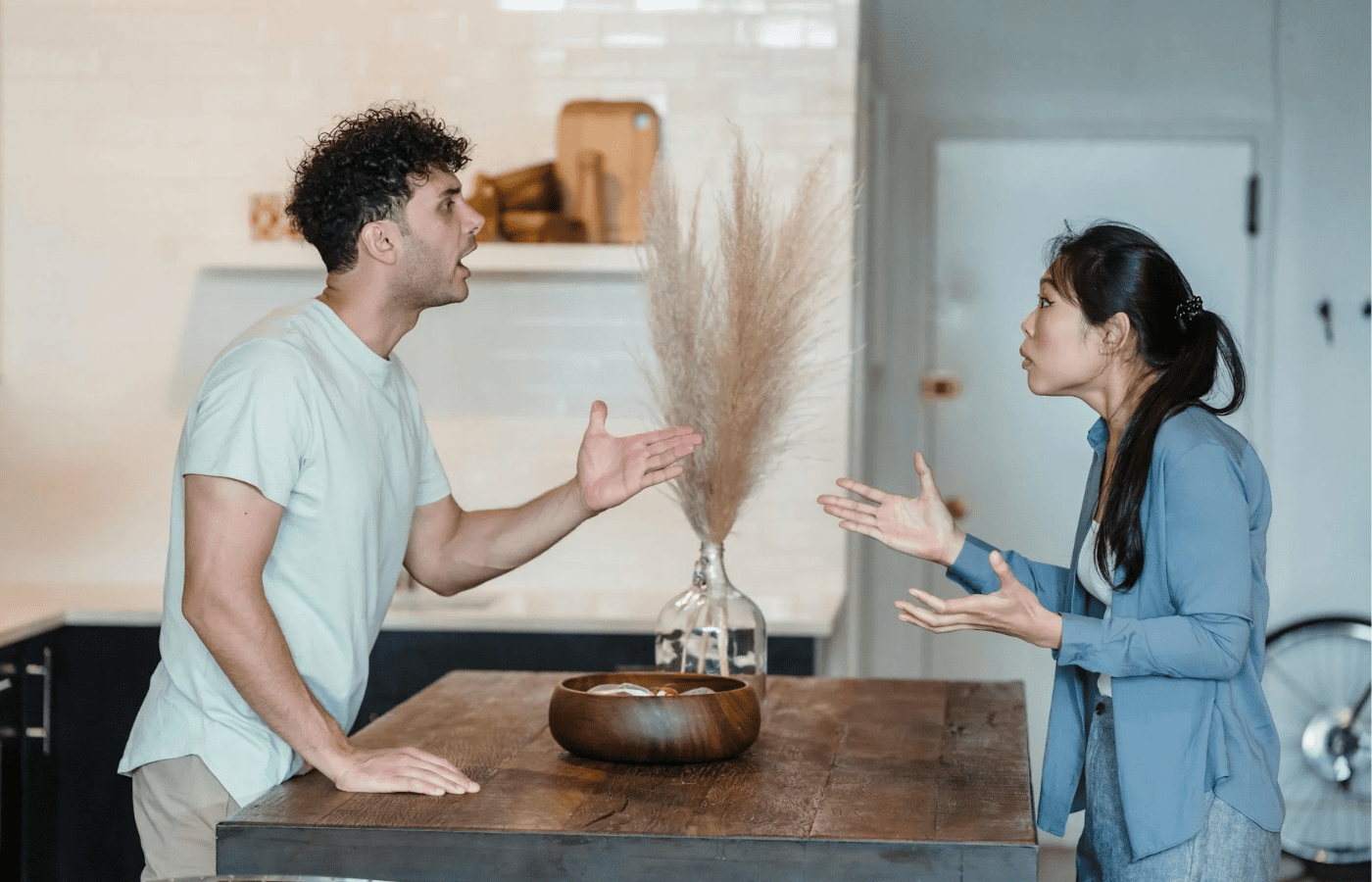 A couple having a serious conversation at a kitchen table