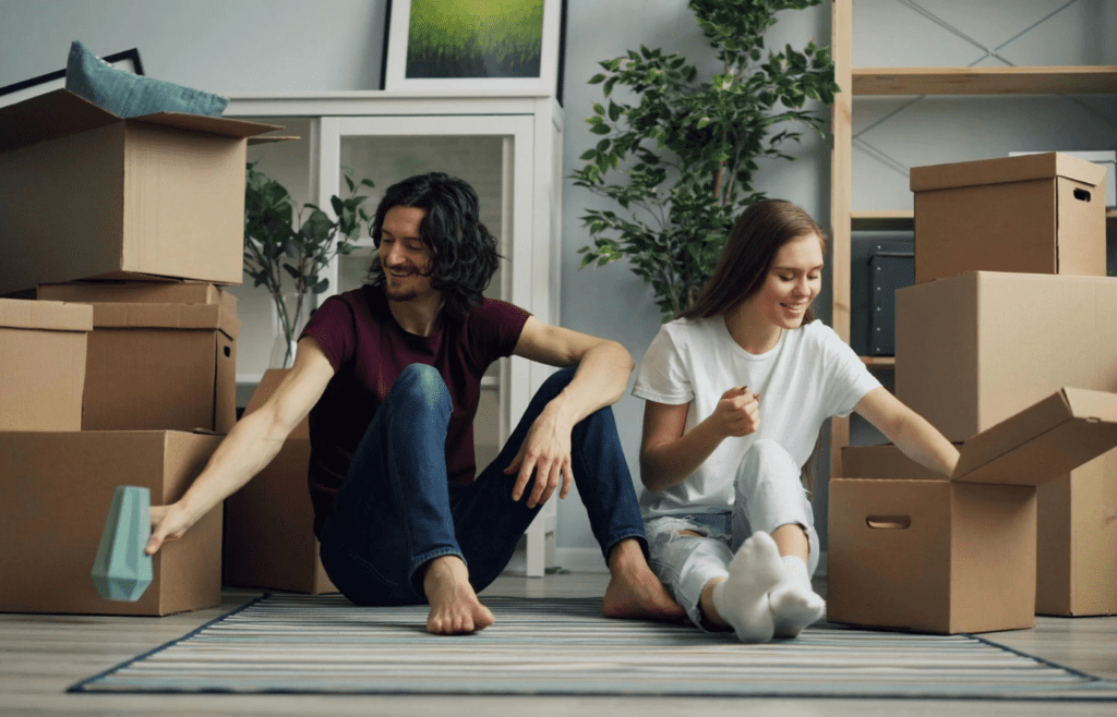 A couple smiling while organizing together