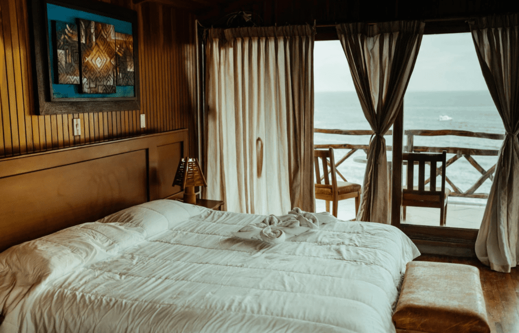A hotel room with an open balcony and scenic view