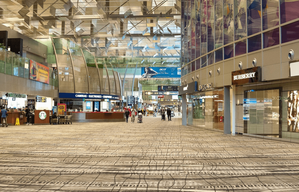 A stylish airport lounge with comfy seating and free snacks