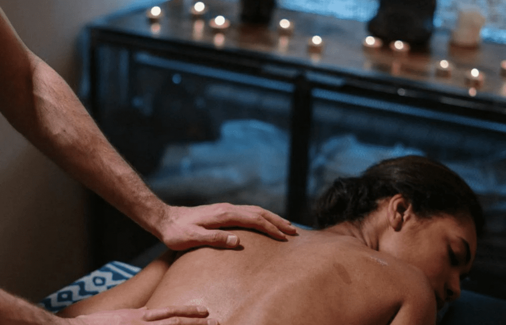 A spa treatment room with candles and soft lighting