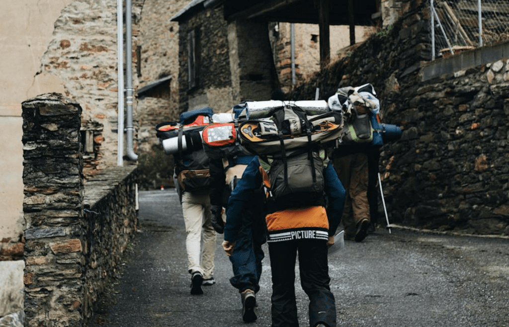A small group hiking or exploring a local village