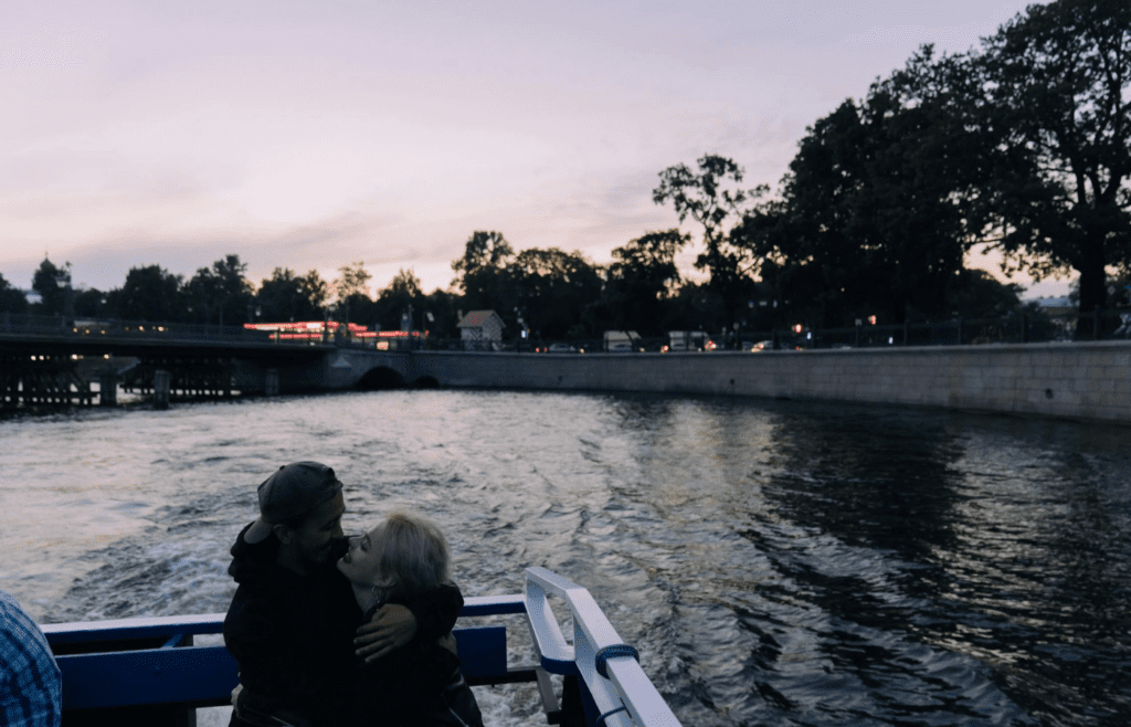 A couple enjoying a small boat ride at sunset