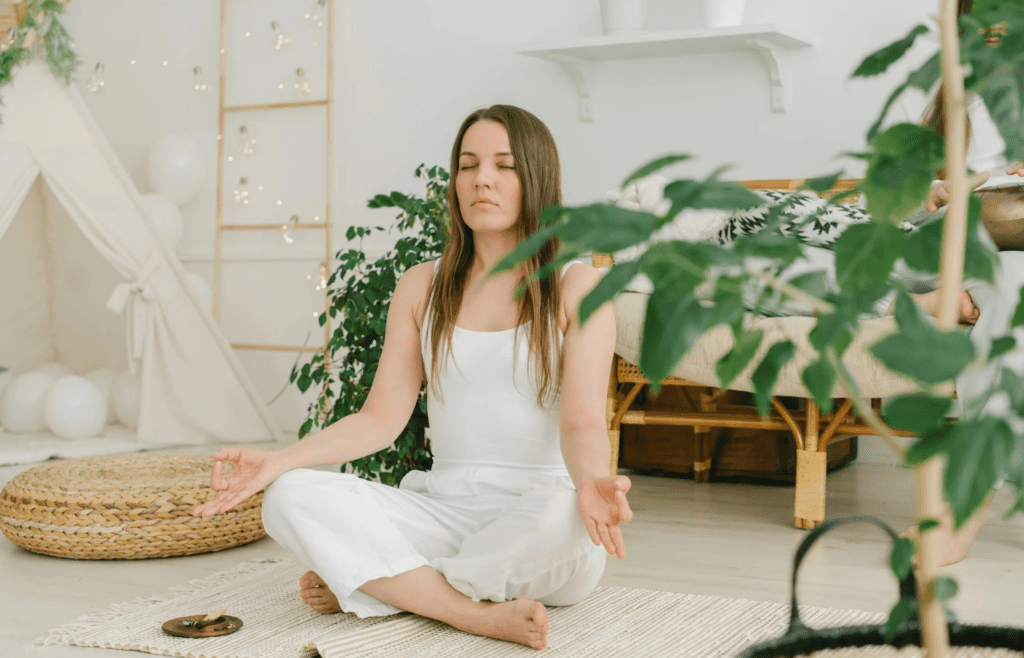 A person sitting calmly with eyes closed
