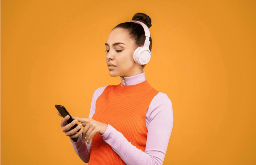 A person with headphones on, eyes closed
