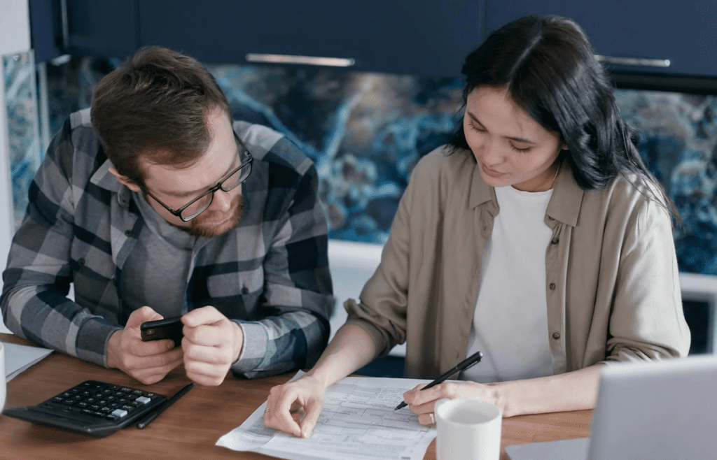 A couple sitting together, reviewing a list or journaling
