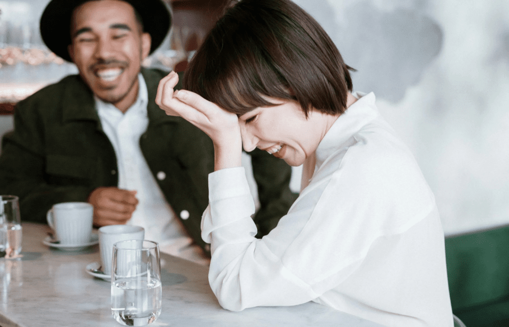 A couple shrugging off a minor annoyance with a laugh