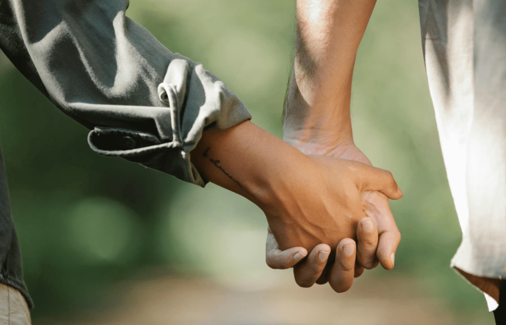 A couple holding hands in quiet appreciation