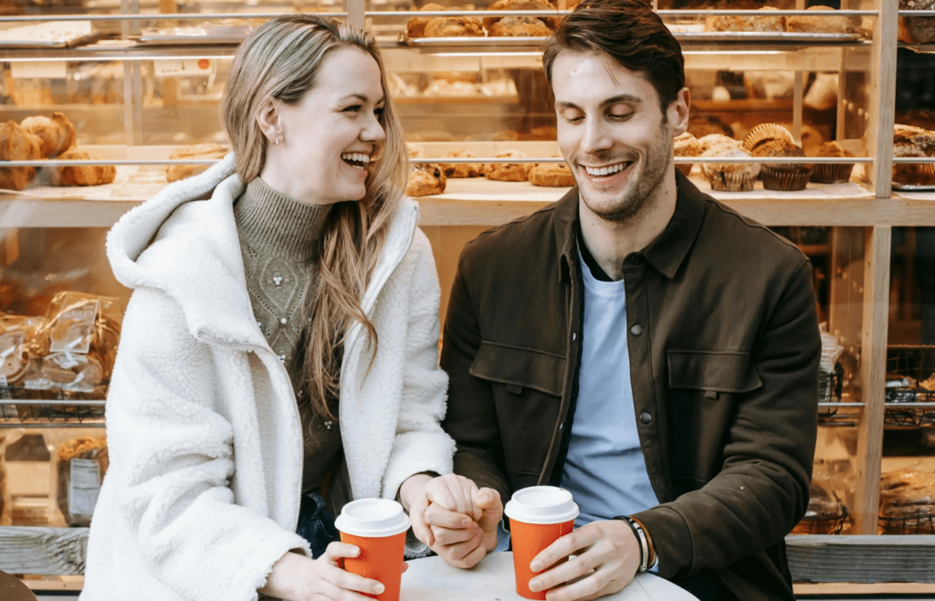 A couple laughing over coffee