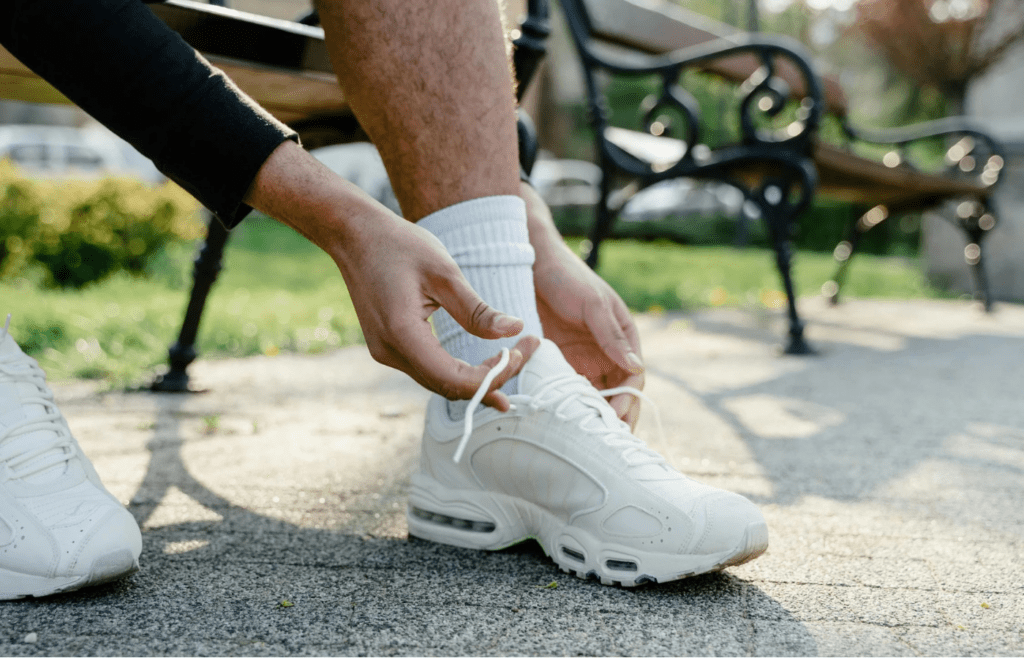 A traveler tying sturdy walking shoes
