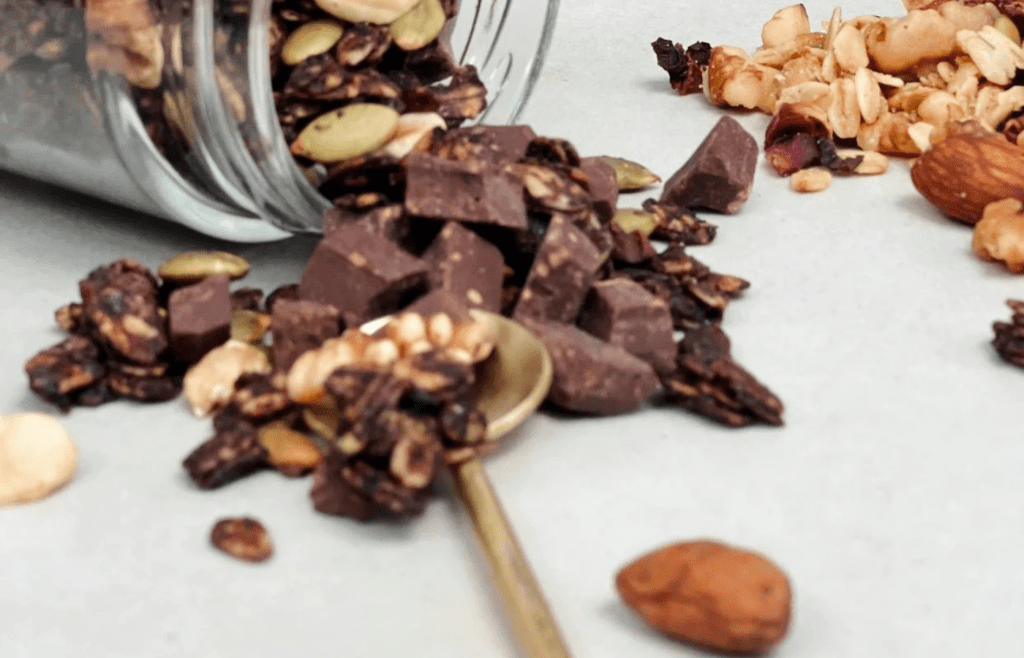 A bag of trail mix and granola bars packed in a carry-on