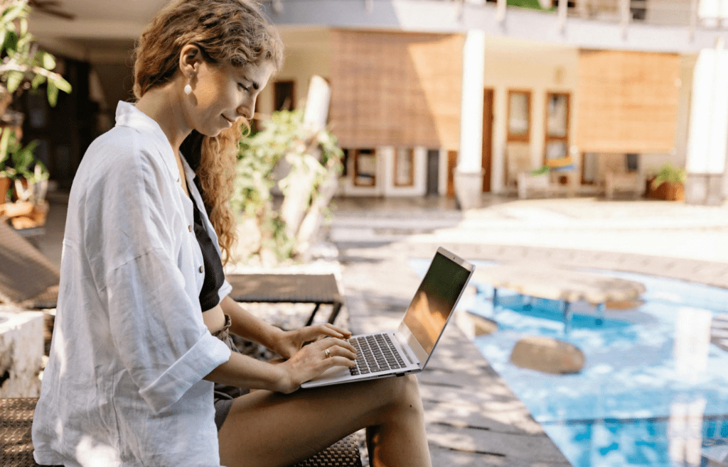 A person booking travel on a laptop