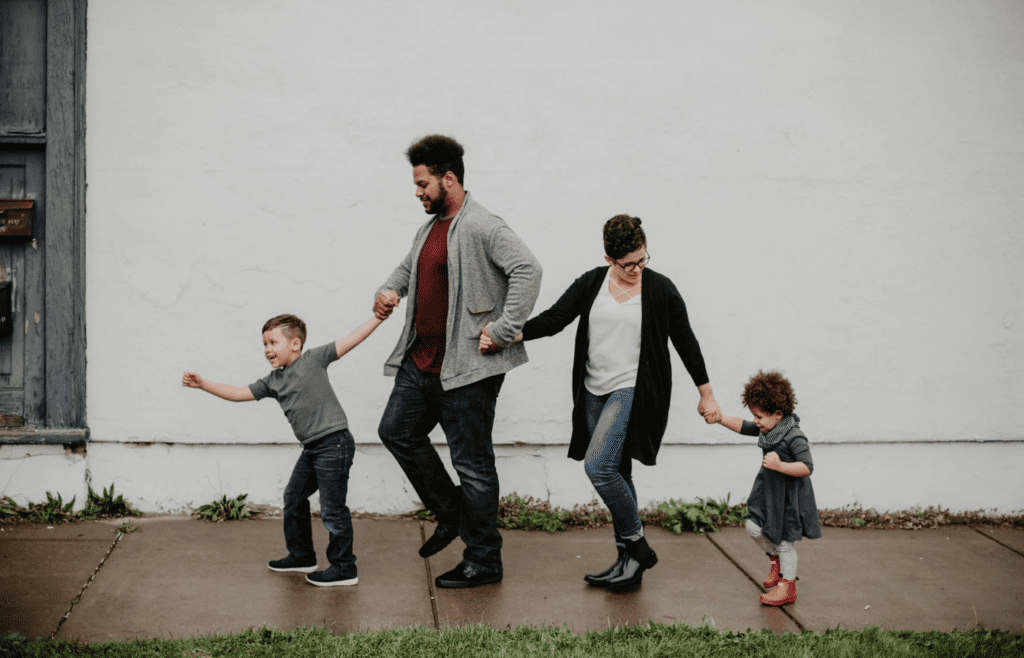 A couple tending to kids while ignoring each other