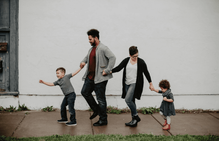 A couple tending to kids while ignoring each other