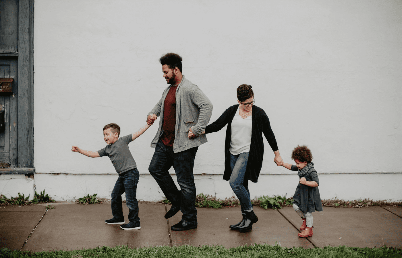 A couple tending to kids while ignoring each other