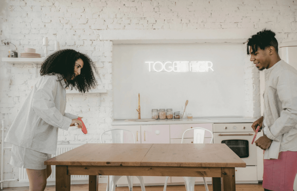 A couple dancing in the kitchen or playing a game