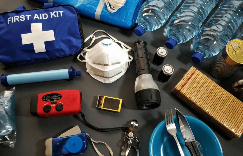 A kit with flashlights, batteries, water, and canned food