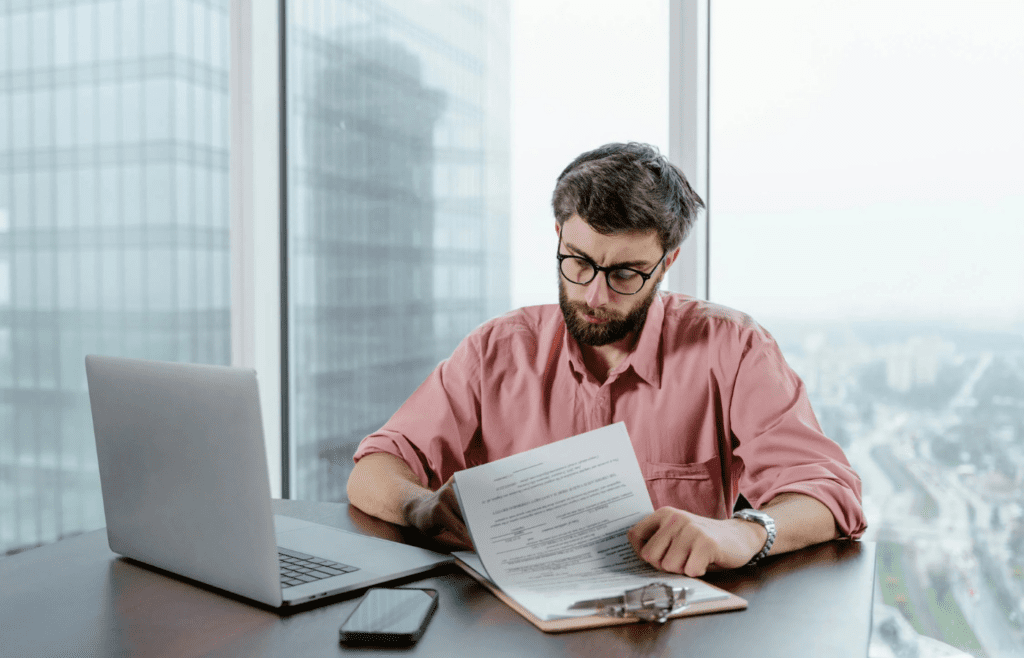 A person reviewing insurance papers at a desk
