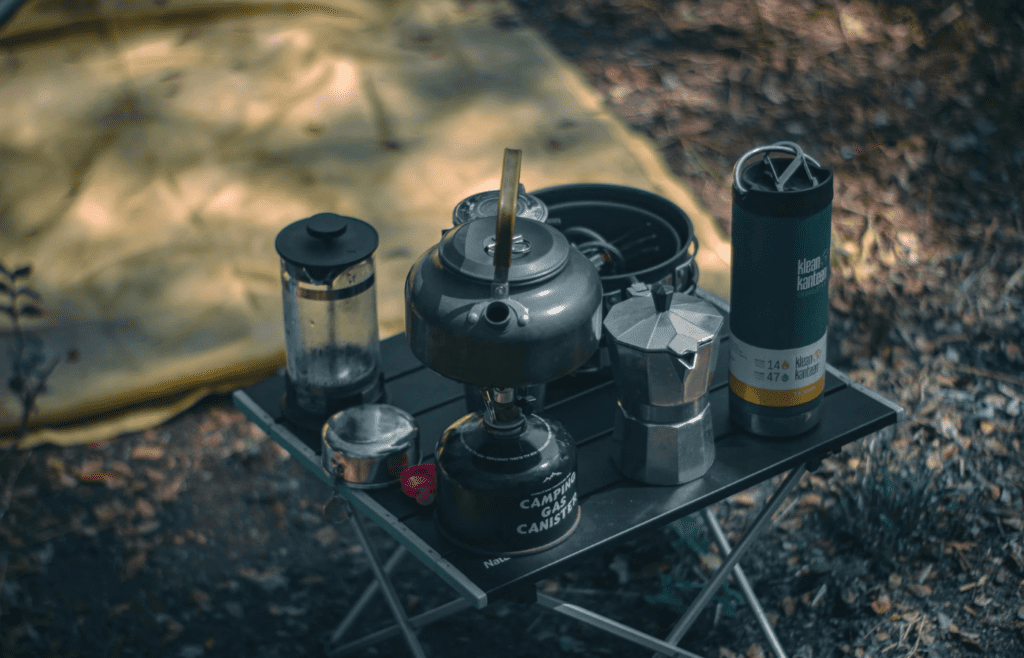 A French press or pour-over setup at a campsite