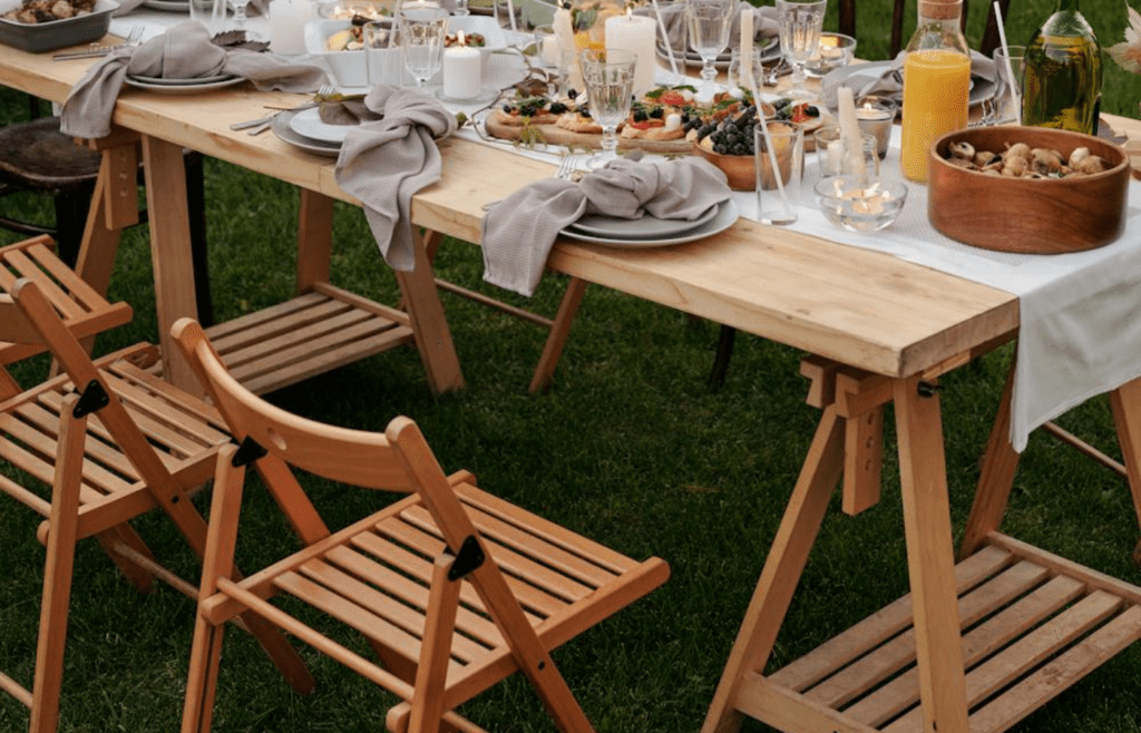 A small folding table with a cute tablecloth and candles