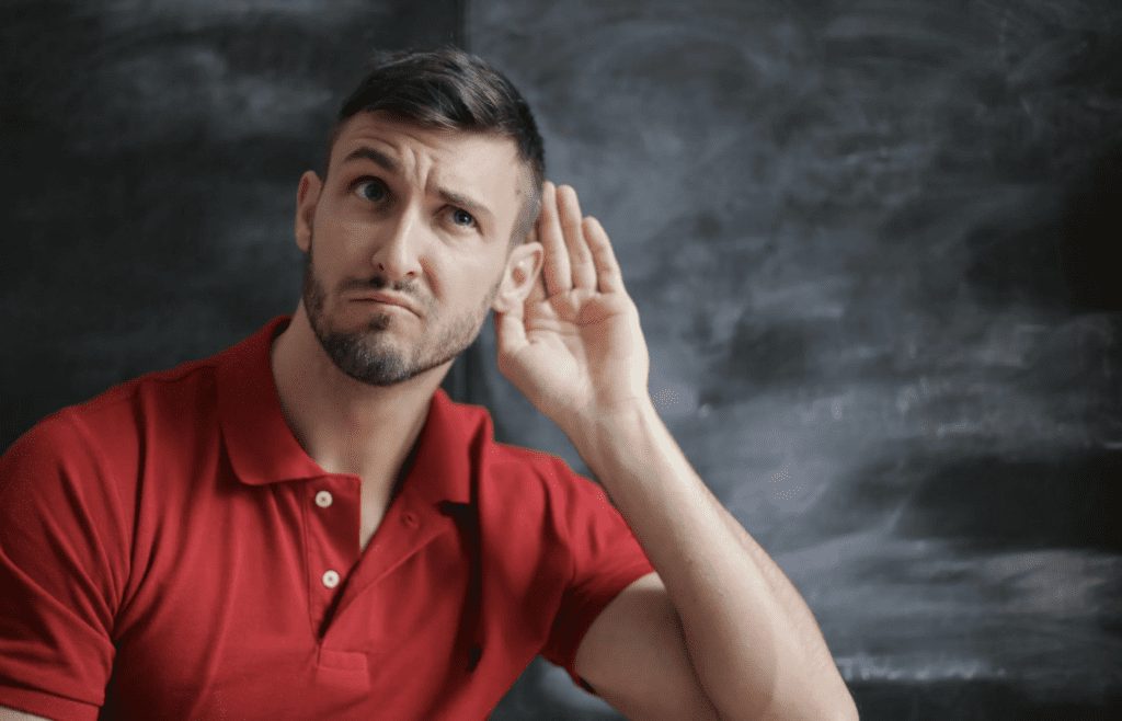 Someone looking insecure while hearing about someone else’s success