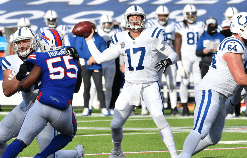 Jan 9, 2021; Orchard Park, New York, USA; Indianapolis Colts quarterback Philip Rivers (17) throws a pass as Buffalo Bills defensive end Jerry Hughes (55) rushes in the second quarter at Bills Stadium.