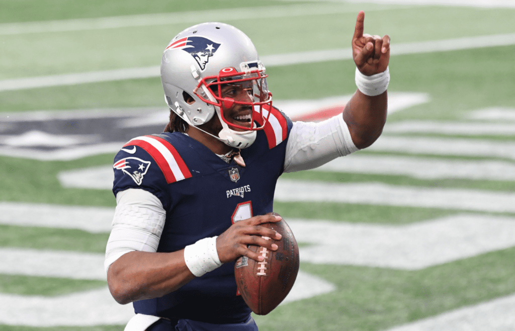 Jan 3, 2021; Foxborough, Massachusetts, USA; New England Patriots quarterback Cam Newton (1) celebrates after scoring a touchdown against the New York Jets during the third quarter at Gillette Stadium. Mandatory Credit: Brian Fluharty-Imagn Images