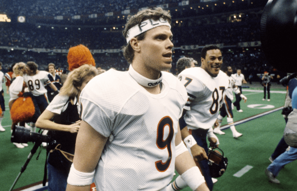 Jan 26, 1986; New Orleans, LA, USA; FILE PHOTO; Chicago Bears quarterback Jim McMahon (9), tight end Emery Moorehead (87) and teammates walk off the field after defeating the New England Patriots 46-10 to win Super Bowl XX at the Superdome. Mandatory Credit: Manny Rubio-Imagn Images